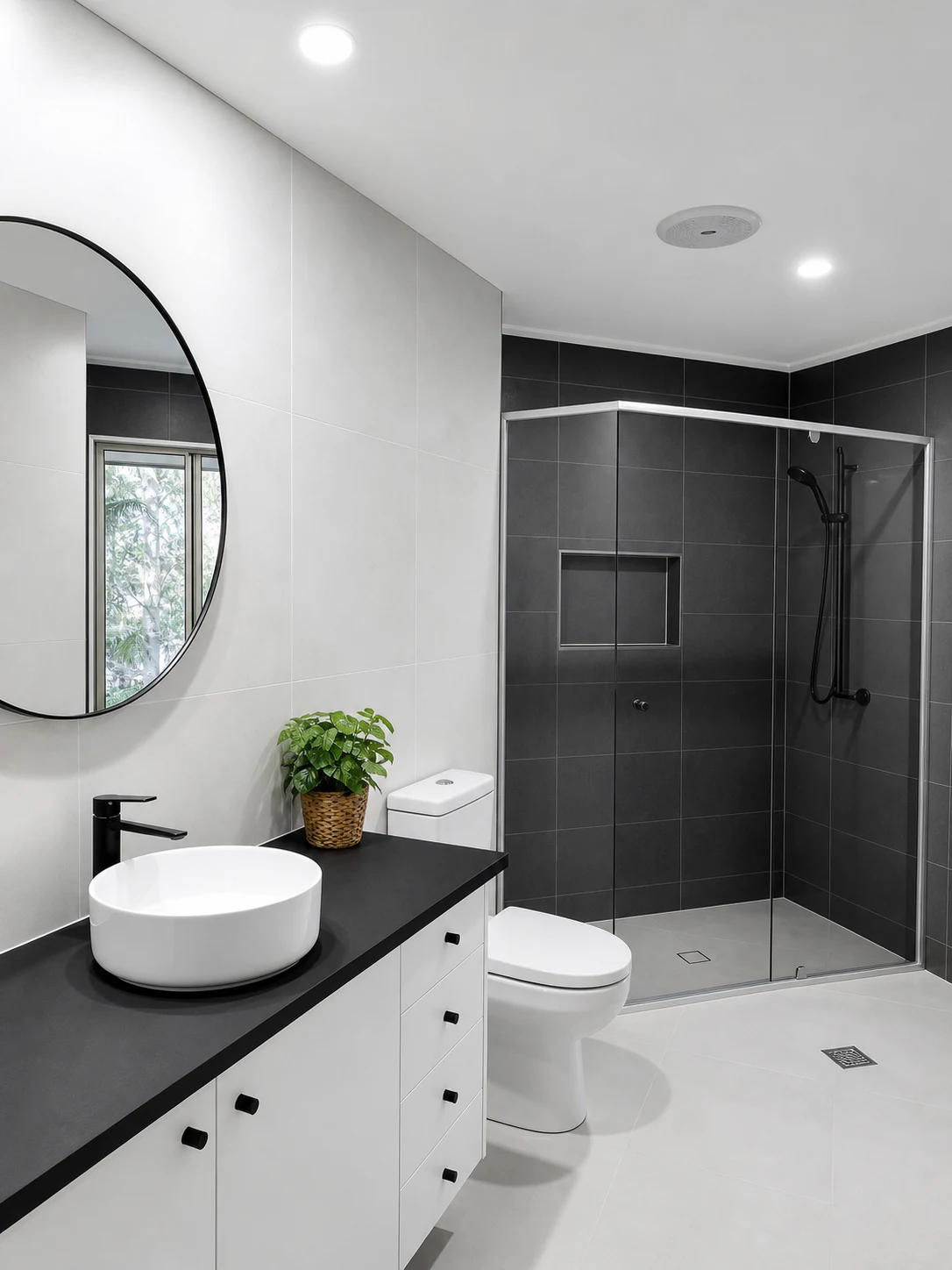 Finished bathroom suite — dark tile and glass